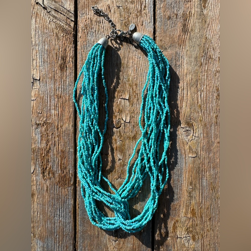 Turquoise necklace with silver detailing for sale.